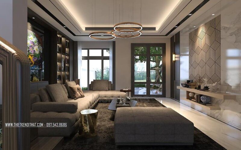 Bố trí nội thất phòng khách ấn tượng với cách kết hợp hài hòa giữa sắc trầm và sáng cùng hệ cửa kính lớn giúp không gian trở nên thông thoáng, sang trọng. Thiết kế nội thất